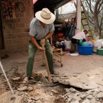 Don Eramso removes the pavement around his home because it is infested with fire ants.