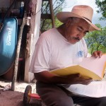 Don Erasmo sits outside his home tries to go over the letters he received form the local government. Don Erasmo never finished school and never learned to read and write.