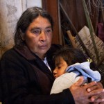 Don Erasmo’s wife, Humbierta, hold hers granddaughter Bety as she falls asleep in her arms.