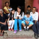 Julian's family sits on the steps of their home on a hill in Tenancingo, Mexico.