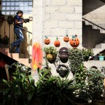 Luis' daughter brings down food from the house into the courtyard where both work is done and meals are served.