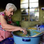 Josefina spends most of her day in the kitchen hunched over her wood-fire stove. She must constantly stir the milk candies as she is making them or they will burn.