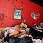 Fernanda, Paloma's daughter, relaxes with dogs on her bed. Fernanda is a manicure technician and she shares Paloma's love of dog. She always helps Paloma with the care of the animals.